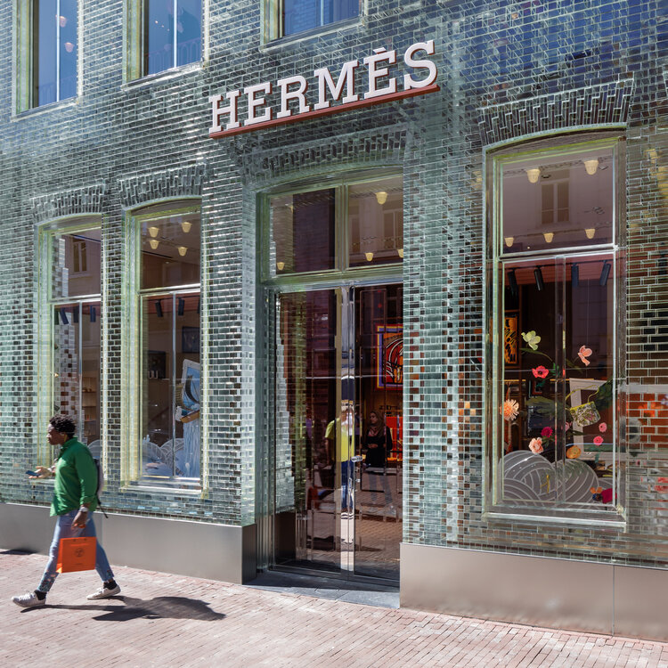 Customer leaves Hermès in Amsterdam with the coveted orange bag. Image  Via